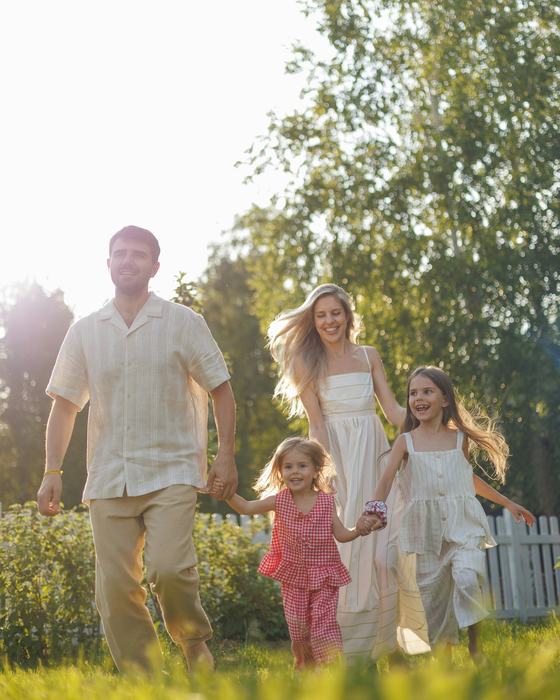 Familie läuft lachend durch den Garten